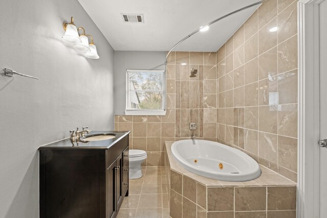 bathroom featuring vanity, tile walls, tile patterned floors, and toilet