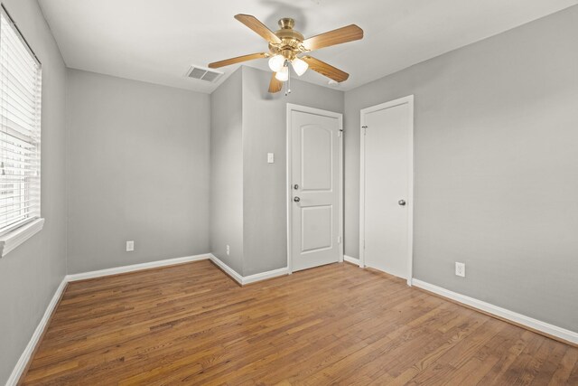 unfurnished room featuring hardwood / wood-style flooring and ceiling fan