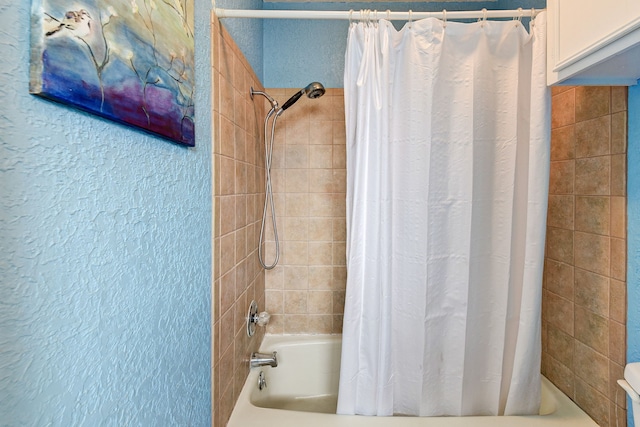 bathroom with shower / bathtub combination with curtain