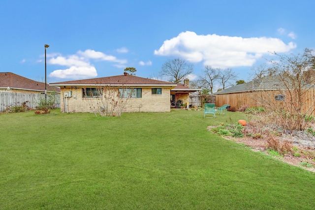 rear view of property with a yard