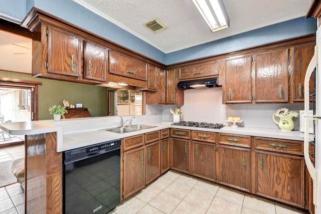 kitchen featuring a breakfast bar, dishwasher, sink, kitchen peninsula, and a textured ceiling