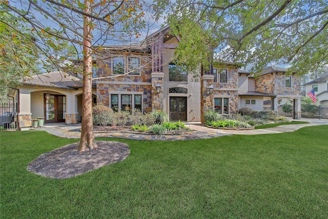 view of front of home with a front yard and french doors