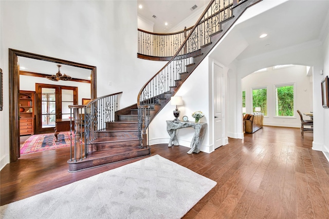 foyer featuring crown molding, a high ceiling, french doors, and hardwood / wood-style flooring