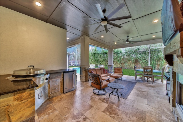 view of patio / terrace featuring an outdoor living space, area for grilling, and ceiling fan