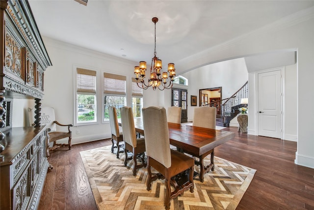 dining space with an inviting chandelier, dark wood-type flooring, and ornamental molding