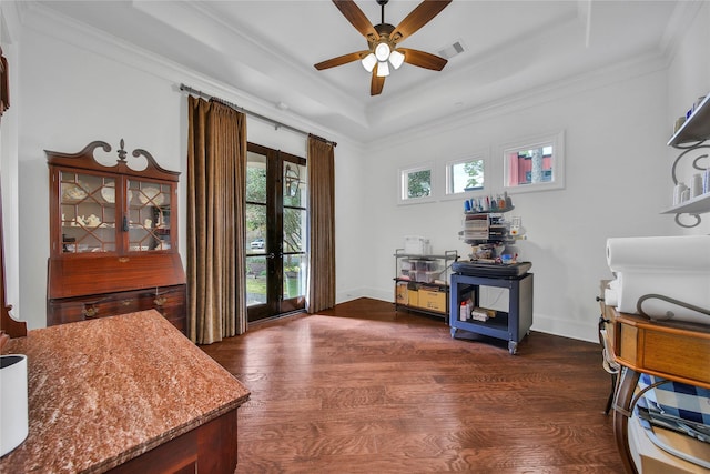 interior space with crown molding, ceiling fan, french doors, dark hardwood / wood-style flooring, and a raised ceiling