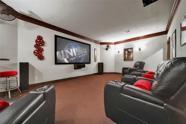 carpeted home theater featuring ornamental molding