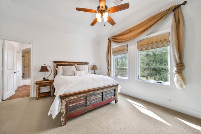 bedroom featuring ensuite bath, vaulted ceiling, ceiling fan, and carpet flooring