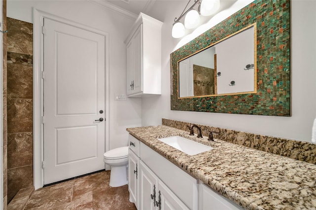 bathroom featuring ornamental molding, toilet, and vanity