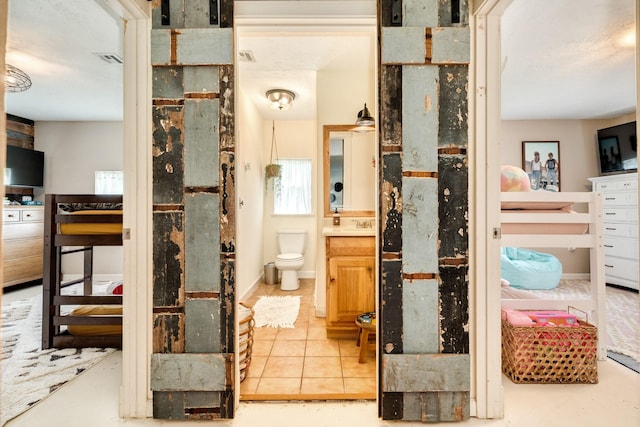 bathroom with vanity, tile patterned floors, and toilet