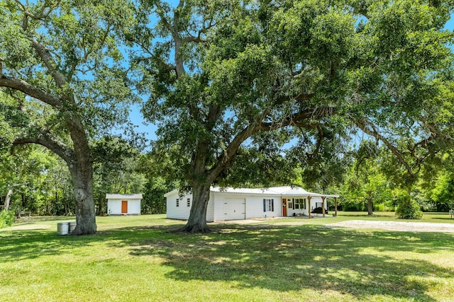 view of front of home with a garage and a front lawn