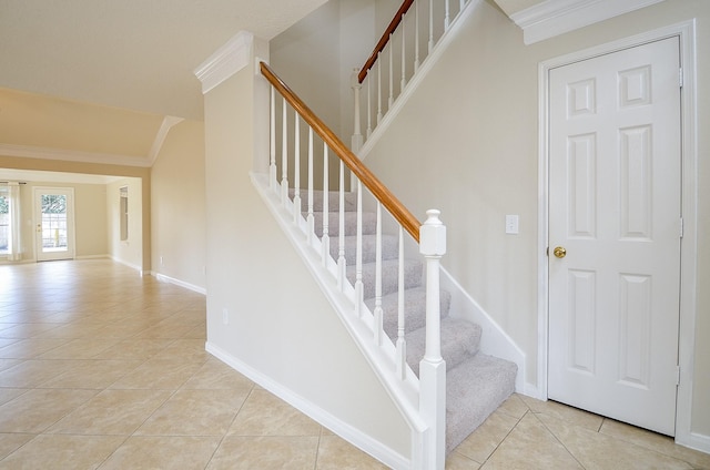 stairway featuring ornamental molding and tile patterned floors