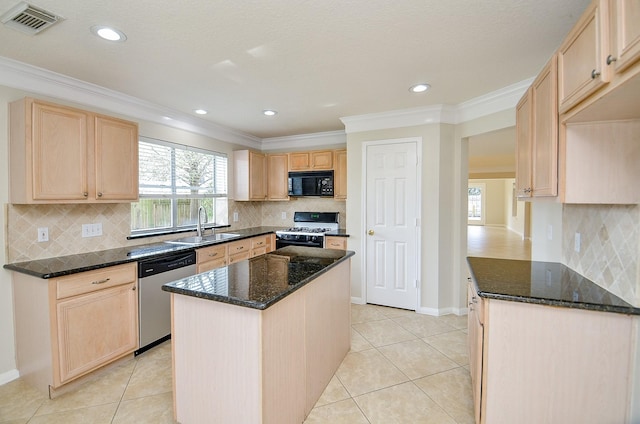 kitchen with a kitchen island, gas range oven, dishwasher, and light brown cabinetry