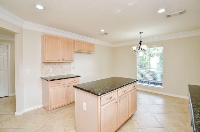 kitchen featuring crown molding, light brown cabinetry, decorative backsplash, and pendant lighting