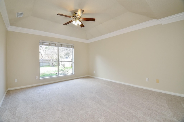 carpeted empty room with a raised ceiling, crown molding, vaulted ceiling, and ceiling fan