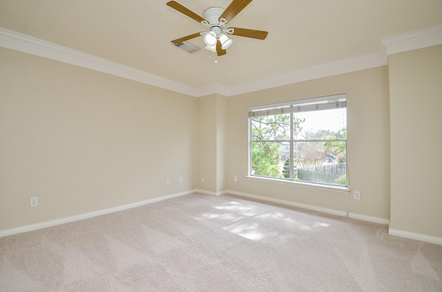 carpeted empty room featuring ceiling fan and ornamental molding