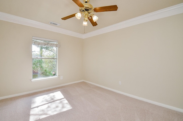 spare room featuring crown molding, carpet, and ceiling fan