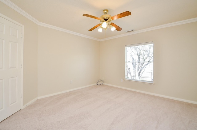 empty room featuring ornamental molding, light carpet, and ceiling fan