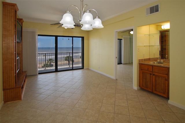 unfurnished dining area featuring ceiling fan with notable chandelier, ornamental molding, light tile patterned flooring, and sink