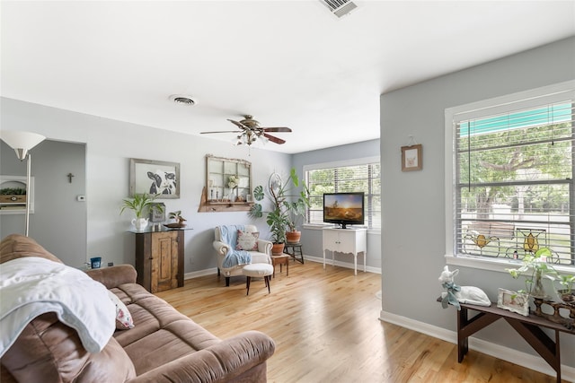 living room with ceiling fan and light wood-type flooring