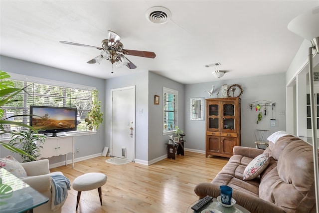 living room with light hardwood / wood-style flooring and ceiling fan