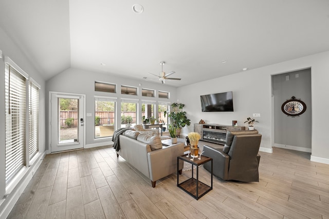 living room with lofted ceiling, ceiling fan, and light hardwood / wood-style flooring