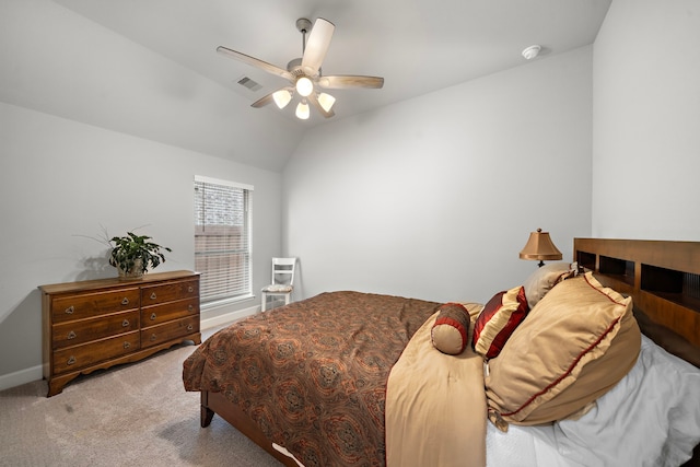 bedroom featuring vaulted ceiling, light colored carpet, and ceiling fan