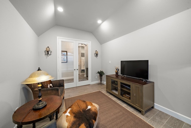 living room with french doors, vaulted ceiling, and light hardwood / wood-style flooring