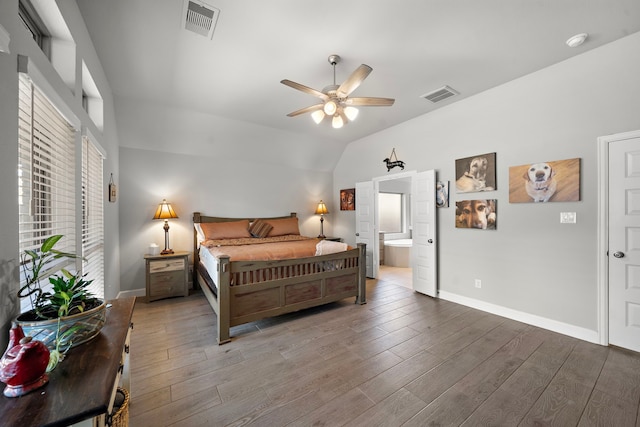 bedroom featuring lofted ceiling, hardwood / wood-style floors, ceiling fan, and ensuite bathroom