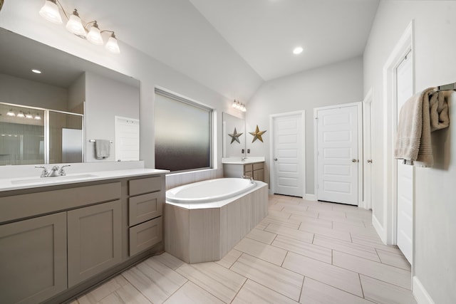 bathroom featuring vanity and shower with separate bathtub