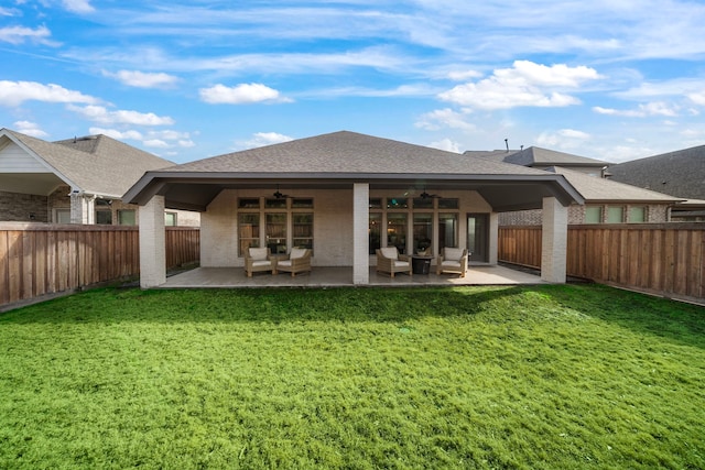 back of property featuring ceiling fan, a yard, and a patio area