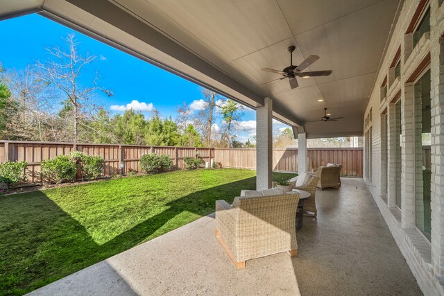 view of yard with ceiling fan and a patio area