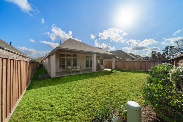 back of property featuring a yard and a patio area