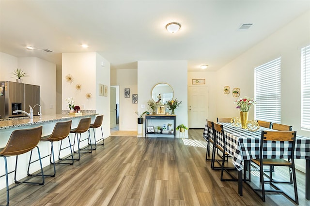 dining room with sink and hardwood / wood-style floors