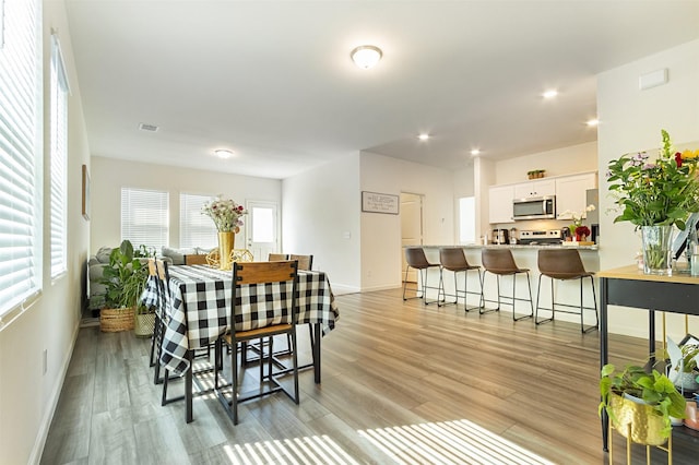 dining space featuring light wood-type flooring