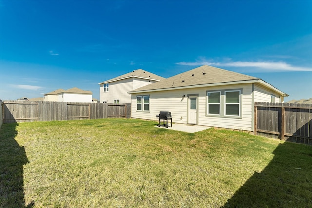 rear view of property with a patio and a lawn