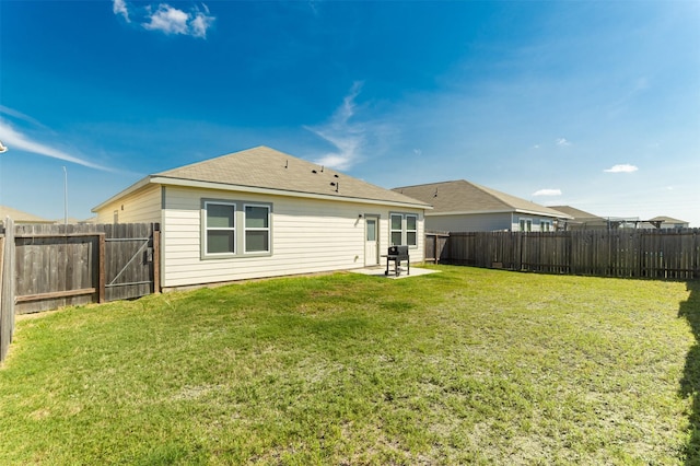 rear view of property with a yard and a patio