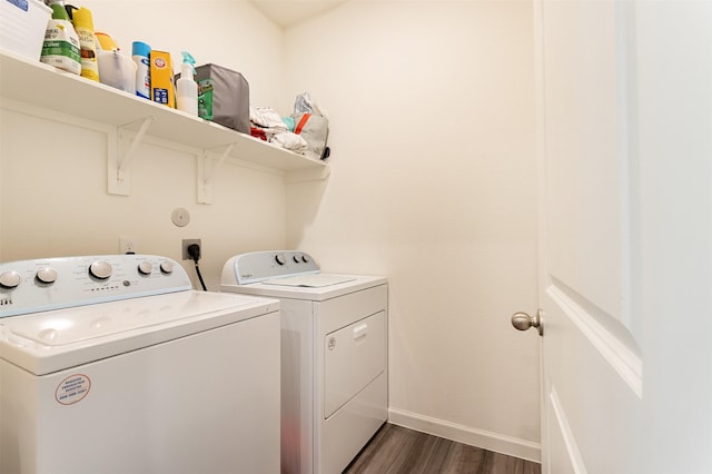 laundry area featuring dark hardwood / wood-style floors and washer and clothes dryer