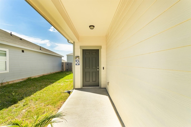 doorway to property featuring a lawn