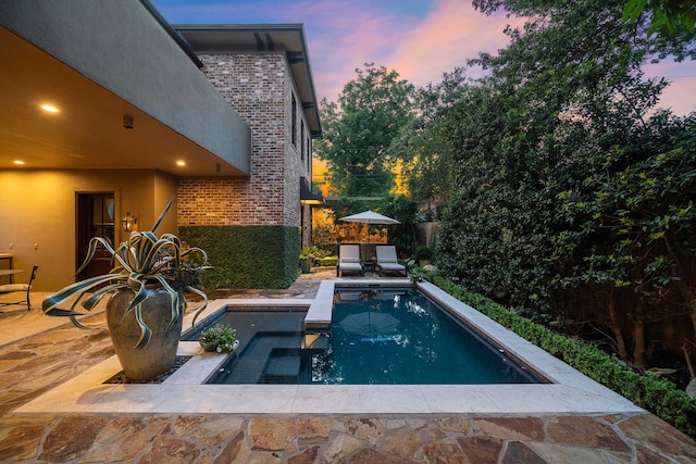 pool at dusk featuring a fenced in pool, a patio, and fence