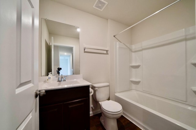 full bathroom with vanity, hardwood / wood-style floors, shower / bathtub combination, and toilet