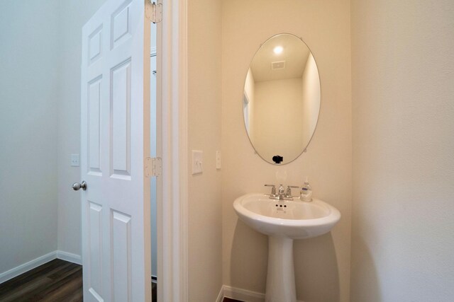 bathroom with wood-type flooring