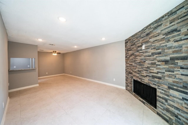 unfurnished living room with ceiling fan, a fireplace, and light tile patterned floors