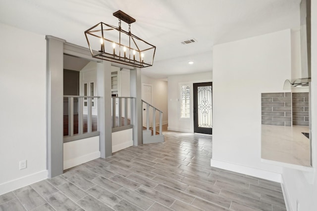 foyer featuring a chandelier