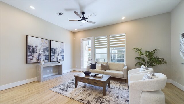 living room featuring ceiling fan and light hardwood / wood-style flooring