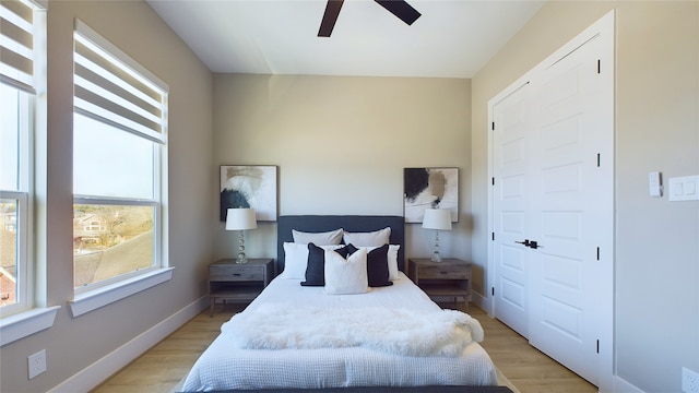 bedroom with ceiling fan and light wood-type flooring