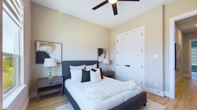 bedroom with ceiling fan and light hardwood / wood-style floors