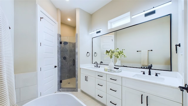 bathroom featuring tile patterned flooring, vanity, and plus walk in shower