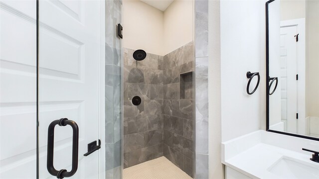 bathroom with an enclosed shower and vanity