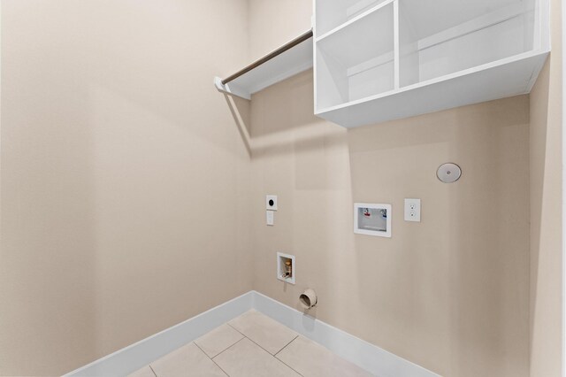 4013 Griggs Rd Unit L, Houston, TX 77021 - washroom with laundry area, baseboards, washer hookup, light tile patterned floors, and hookup for a gas dryer
